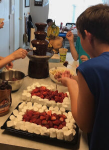 Shavuot Pentecost chocolate fondue fountain with strawberries and marshmallows